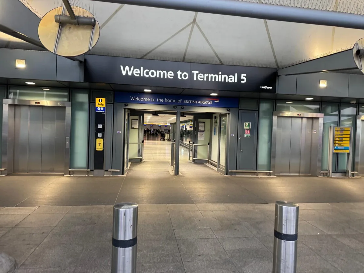 Entrance to Heathrow Terminal 5 at first light, with the Welcome to the home of British Airways sign above the doors
